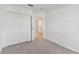 Bedroom featuring gray carpet, a closet with bi-fold doors, and an open door to the hallway at 5425 Tripoli Dr, Palmetto, FL 34221