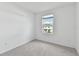 Bedroom features gray carpet, white walls, a window with blinds, and a baseboard at 5425 Tripoli Dr, Palmetto, FL 34221
