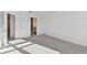 Bright bedroom with gray carpet, an open door to the ensuite bathroom, and recessed lighting at 5425 Tripoli Dr, Palmetto, FL 34221