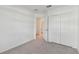Neutral bedroom with carpet, an ensuite bathroom, and a closet with bi-fold doors at 5425 Tripoli Dr, Palmetto, FL 34221
