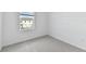 Bedroom features gray carpet, white walls, a window, and baseboards at 5425 Tripoli Dr, Palmetto, FL 34221