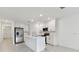 Bright, modern kitchen featuring an island, stainless appliances, white cabinets and tile flooring at 5425 Tripoli Dr, Palmetto, FL 34221