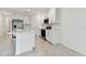 Modern kitchen featuring island, stainless steel appliances, white cabinets, and stylish tile flooring at 5425 Tripoli Dr, Palmetto, FL 34221
