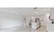 Open kitchen with an island featuring stainless steel appliances, white cabinets and tile flooring at 5425 Tripoli Dr, Palmetto, FL 34221