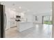 Bright, open kitchen boasts an island with seating, stainless steel appliances, and tile flooring at 5425 Tripoli Dr, Palmetto, FL 34221