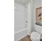 Clean bathroom with white subway tiles, modern fixtures, and a gray rolled towel on the toilet at 7959 Chandler Lake Ct, Hudson, FL 34667