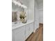 Elegant bathroom featuring a double sink vanity, a walk-in shower, and ample storage space at 7959 Chandler Lake Ct, Hudson, FL 34667