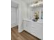Modern bathroom featuring double vanity, sleek white cabinetry, and a separate shower and tub at 7959 Chandler Lake Ct, Hudson, FL 34667