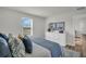 Bright bedroom featuring a comfortable bed, stylish dresser, and a window with a scenic view at 7959 Chandler Lake Ct, Hudson, FL 34667