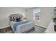 Serene bedroom with a queen-size bed, neutral decor, and plenty of natural light from the window at 7959 Chandler Lake Ct, Hudson, FL 34667