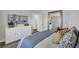 Bright bedroom with a light-colored dresser, large mirror, and soothing decor at 7959 Chandler Lake Ct, Hudson, FL 34667