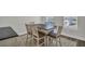 Dining room features a rustic table with seating for six and natural light from a large window at 7959 Chandler Lake Ct, Hudson, FL 34667
