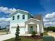 Beautiful two-story home with a light blue exterior, a two-car garage, and a well-manicured lawn at 7959 Chandler Lake Ct, Hudson, FL 34667
