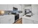 Kitchen featuring stainless steel appliances and subway tile backsplash at 7959 Chandler Lake Ct, Hudson, FL 34667