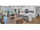 Modern kitchen with white countertops, a wooden dining table and a view to the living room at 7959 Chandler Lake Ct, Hudson, FL 34667