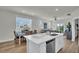 Modern kitchen features white cabinets, stainless steel appliances, and a peninsula overlooking the dining area at 7959 Chandler Lake Ct, Hudson, FL 34667