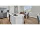 Well-lit kitchen with stainless steel appliances and dining area with wooden table at 7959 Chandler Lake Ct, Hudson, FL 34667