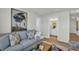 Inviting living room featuring a comfortable sofa, modern decor, and an adjacent bathroom at 7959 Chandler Lake Ct, Hudson, FL 34667