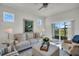 Sunlit living room with sliding glass doors leading to screened in patio at 7959 Chandler Lake Ct, Hudson, FL 34667