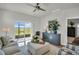 Bright living room with sliding glass doors and ceiling fan at 7959 Chandler Lake Ct, Hudson, FL 34667