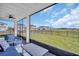 Relaxing screened-in patio with comfortable seating and views of the community green space at 7959 Chandler Lake Ct, Hudson, FL 34667