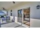 Covered patio with comfortable seating and a view into the kitchen, ideal for outdoor relaxation and entertaining at 7959 Chandler Lake Ct, Hudson, FL 34667