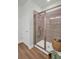Walk-in shower features tiled walls, glass door, and a rainfall shower head at 7959 Chandler Lake Ct, Hudson, FL 34667