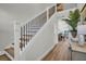 Bright foyer featuring an oak staircase and view of dining area at 7959 Chandler Lake Ct, Hudson, FL 34667