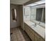Well-lit bathroom with ample counter space, storage, and a large mirror at 8744 54Th W Ave # 8744, Bradenton, FL 34210