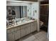 Bathroom featuring a large vanity, white cabinets, and a door to the shower/toilet room at 8744 54Th W Ave # 8744, Bradenton, FL 34210