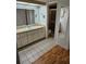 Bathroom featuring an extra long vanity, white cabinets and a door to the toilet at 8744 54Th W Ave # 8744, Bradenton, FL 34210