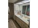 Well-lit bathroom with ample counter space, storage, and a large mirror at 8744 54Th W Ave # 8744, Bradenton, FL 34210