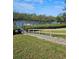 A well-maintained dock and waterway with tropical foliage at 8744 54Th W Ave # 8744, Bradenton, FL 34210