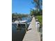 This dock features a boat secured alongside wooden posts, a no-fishing sign, and tranquil water views at 8744 54Th W Ave # 8744, Bradenton, FL 34210