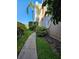 A beautiful condo exterior showcases unique round windows, complemented by lush landscaping and a sidewalk at 8744 54Th W Ave # 8744, Bradenton, FL 34210