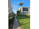 A beautiful condo exterior featuring lush landscaping and well-maintained grounds, with a sidewalk in view at 8744 54Th W Ave # 8744, Bradenton, FL 34210