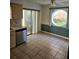 The eat-in kitchen is spacious with tile flooring, stainless steel appliances, and a unique round window at 8744 54Th W Ave # 8744, Bradenton, FL 34210