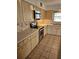 Well-lit kitchen featuring tile backsplash, stainless steel microwave, electric range and a window to let in natural light at 8744 54Th W Ave # 8744, Bradenton, FL 34210