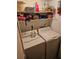 Laundry room featuring a washing machine, dryer, and storage shelves at 8744 54Th W Ave # 8744, Bradenton, FL 34210