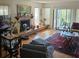 Bright living room with brick fireplace, wooden floors, and sliding glass doors to a patio at 8744 54Th W Ave # 8744, Bradenton, FL 34210