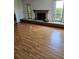 View of the hardwood floors in the expansive living room with a cozy fireplace at 8744 54Th W Ave # 8744, Bradenton, FL 34210
