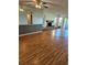 Expansive living room with hardwood floors, fireplace feature, and natural light from large windows at 8744 54Th W Ave # 8744, Bradenton, FL 34210