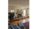 Cozy living room with brick fireplace, wooden floors, and comfortable seating at 8744 54Th W Ave # 8744, Bradenton, FL 34210