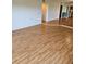 Open living room showcasing continuous hardwood floors and access to other spaces at 8744 54Th W Ave # 8744, Bradenton, FL 34210