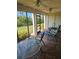 Relaxing screened patio with ceiling fans, tiled floors, and a beautiful view of the lush green lawn at 8744 54Th W Ave # 8744, Bradenton, FL 34210