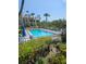 A refreshing pool is surrounded by lounge chairs, tropical trees, and well-maintained landscaping at 8744 54Th W Ave # 8744, Bradenton, FL 34210