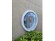 A close-up of a unique round window with tropical foliage at 8744 54Th W Ave # 8744, Bradenton, FL 34210