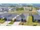 Aerial view of a home with a long driveway, manicured lawn, and a nearby pond at 11820 Stone Pine St, Riverview, FL 33569