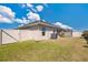 Backyard with green grass, vinyl fence, and screened-in patio at 11820 Stone Pine St, Riverview, FL 33569