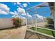 Spacious backyard with a screened-in patio and white vinyl fence at 11820 Stone Pine St, Riverview, FL 33569